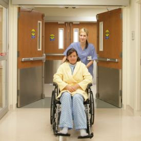 person on a wheelchair passing through an ADA commercial door